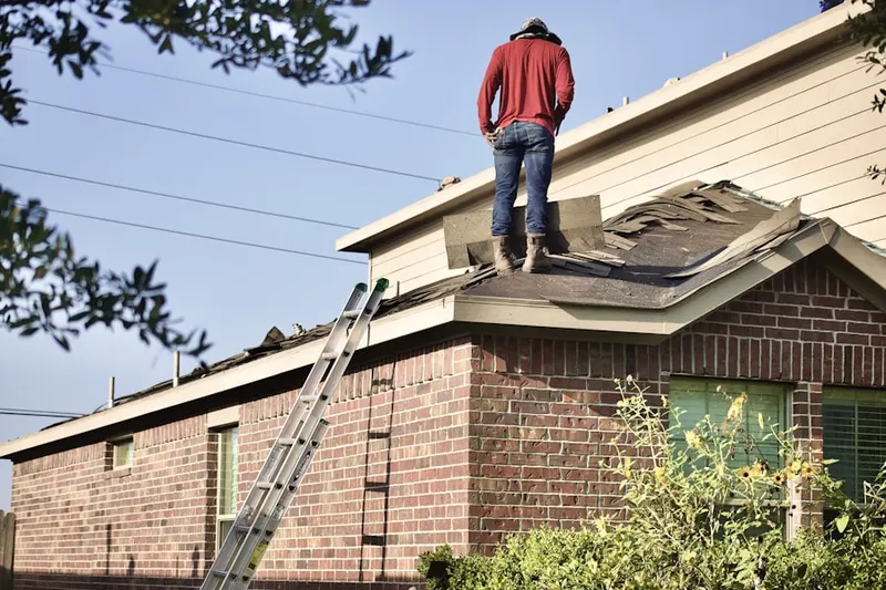 Professional roofer working on a residential roof in Deer Woods